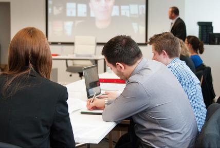 Business students in lesson taking notes at Bournemouth & Poole College