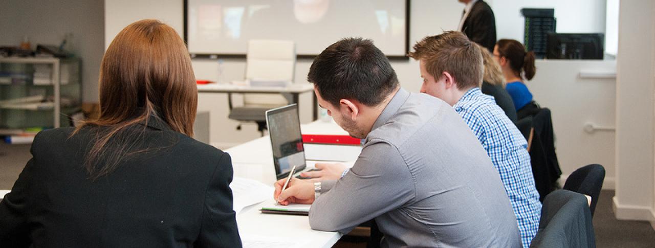 Business students in lesson taking notes at Bournemouth & Poole College