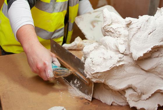 Student using trowel for plastering