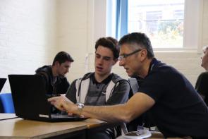 UPS student working with student in classroom